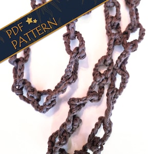 May include: A brown crocheted chain made of interconnected yarn loops. A dark blue diagonal banner overlays the image with gold text that reads PDF PATTERN and features two small gold stars. The chain has a textured, knotted appearance.