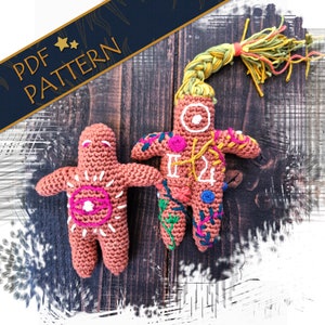 May include: Two crocheted dolls with embroidered details. One doll has a long yellow braid and is decorated with flowers and the number "12". The other doll has a pink and white eye design and a sun-like pattern.