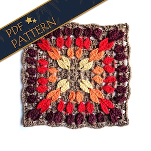 Peut inclure: Modèle de crochet carré avec un motif de feuilles colorées dans les tons de rouge, orange, jaune et marron. Le motif s'appelle "PDF PATTERN" et est disponible en téléchargement.