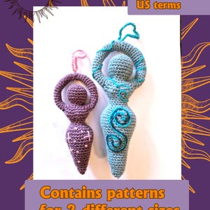 May include: Two crocheted goddess figures with hanging loops. The smaller figure is purple with pink cross-stitch details. The larger figure is light blue with dark blue spiral embroidery. Text reads: MERRY MANDRAKE, English PDF US terms, Contains patterns for 2 different sizes.
