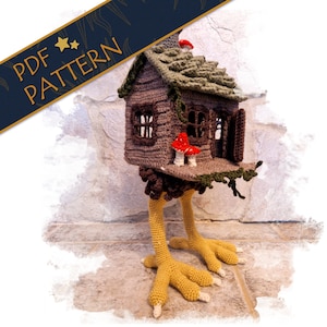 Könnte beinhalten: Häkelhaus mit Beinen und einem Pilz auf der Veranda. Das Haus ist braun mit einem grünen Dach und Fenstern. Die Beine sind gelb und der Pilz ist rot mit weißen Punkten.