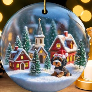 Snow globe style design personalized ceramic bernedoodle ornament with a warm backdrop Christmas dog ornament with festive winter scene.  Great gift idea for doodle moms and doodle dog lovers!