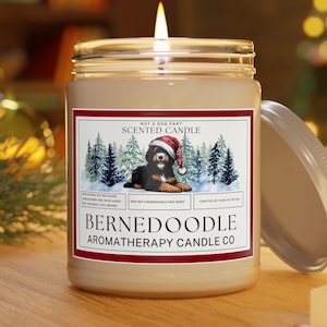 Bernedoodle Candle shown lit, giving off a warm ambiance and glow.
