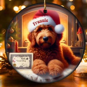 Goldendoodle Ornament - 3 inch round ceramic fully gloss Christmas Ornament hanging with a gold string against a warm background.