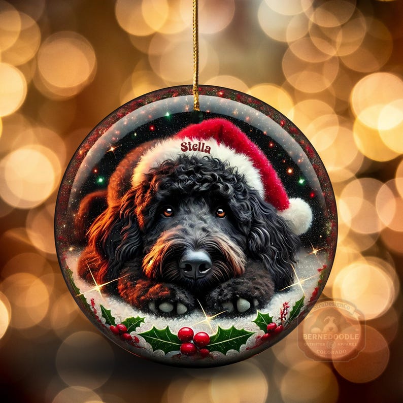 Black bernedoodle or labradoodle dog ceramic ornament show hanging with a gold string.  The ornament measures 3 inches in diameter and is a full gloss, printed on both sides.