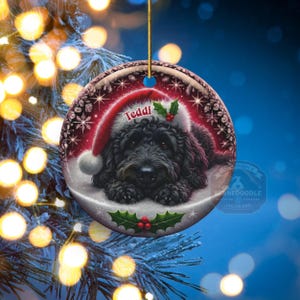 Black bernedoodle or labradoodle dog ceramic ornament show hanging with a gold string.  The ornament measures 3 inches in diameter and is a full gloss, printed on both sides.