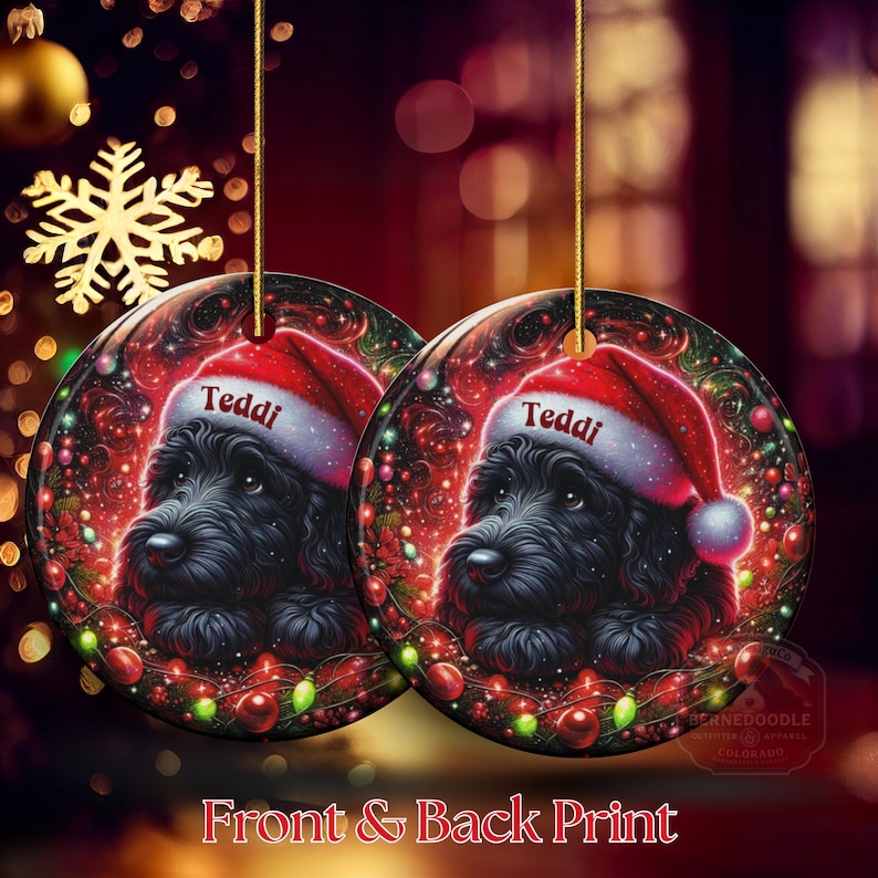 May include: Two round Christmas ornaments with a black dog wearing a Santa hat that says "Teddi". The ornaments have a red and green festive design with a gold string for hanging. The text "Front & Back Print" is at the bottom.