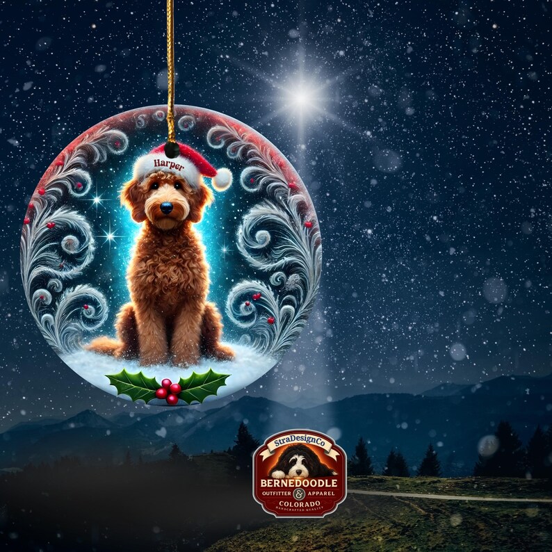 A festive holiday ceramic ornament showcases a curly goldendoodle sitting sweetly in snow beneath a glowing winter sky. The pup wears a Santa hat embroidered with “Harper.” Decorative snow swirls, sparkles, and holly leaves frame the scene. The soft background lights create a magical Christmas atmosphere perfect for dog lovers and personalized tree gifts.