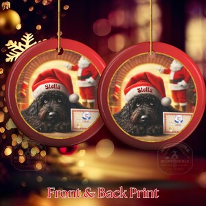 This ceramic ornament features a cute black goldendoodle (or Labradoodle)...Or black bernedoodle dog wearing a Santa hat and being on their best behavior for Santa, surrounded by holiday decorations.  Three inch ceramic dog ornament with a black bernedoodle black golden doodle black goldendoodle dog wearing a santa hat on this cute dog ornament gift.  Perfect ornament for a dog person, dog lover, doodle mom or doodle dad.