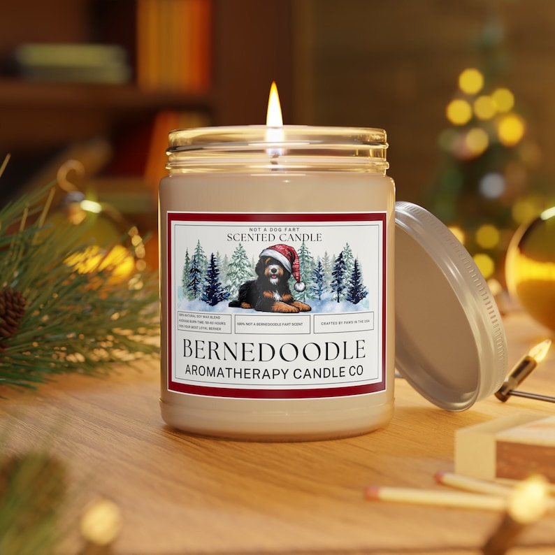 Bernedoodle Candle shown lit, giving off a warm ambiance and glow.