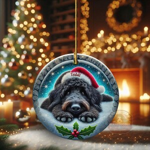 Black goldendoodle ceramic ornament with two sided design.  Black golden doodle , black bernedoodle dog decor.  The picture is showing the ornaments printed on each side.  Gorgeous blue ornament with black doodle dog wearing a santa hat.  Personalized with dog's name.