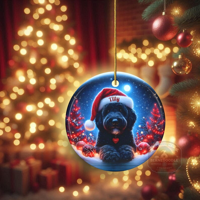 This festive ornament features an adorable black doodle wearing a Santa hat, surrounded by soft glowing holiday lights and rich red Christmas tones. The warm lighting highlights the dog’s fluffy black fur, giving the design a bright, cheerful look that stands out on any tree. A perfect personalized keepsake for anyone who loves black doodles and joyful holiday décor.