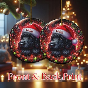 May include: Two round Christmas ornaments with a black dog wearing a Santa hat that says "Teddi". The ornaments have a red and green border with Christmas lights and ornaments. The text "Front & Back Print" is at the bottom.