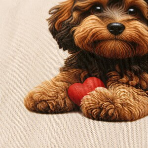 A close-up of a dog's face, with a red heart in its paws, against a textured background.