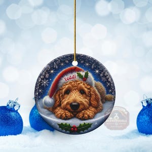 Golden Doodle dog ceramic ornament show hanging with a gold string.  The Goldendoodle Dog ornament measures 3 inches in diameter and is a full gloss, printed on both sides.