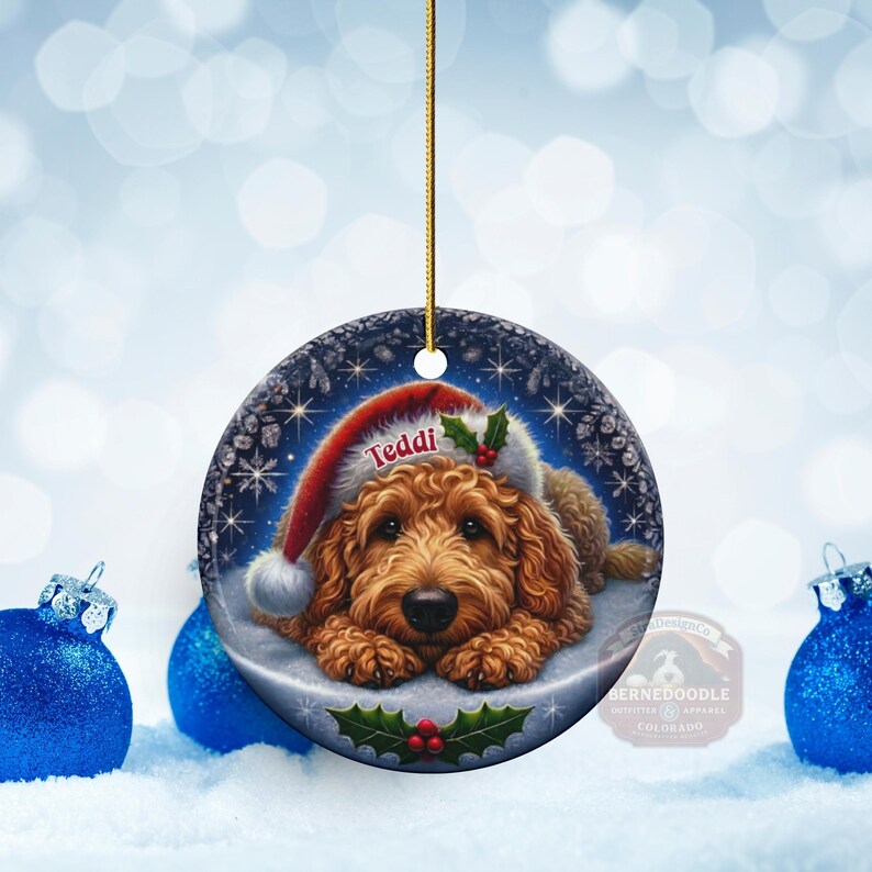 Golden Doodle dog ceramic ornament show hanging with a gold string.  The Goldendoodle Dog ornament measures 3 inches in diameter and is a full gloss, printed on both sides.