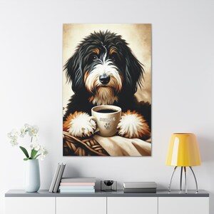 May include: A wall art print featuring a Bernese Mountain Dog with black, white, and tan fur. The dog is holding a beige ceramic mug with the name BERNIE and a paw print graphic printed on the front. The dog is resting its paws on a woven basket.
