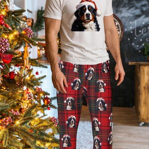 Men's pajama pants lounge wear personalized Christmas pajama bottoms with Bernese Mountain dogs wearing Santa Hat and their name is on the Santa Hat.  Bernese Mountain Dog dad gear!