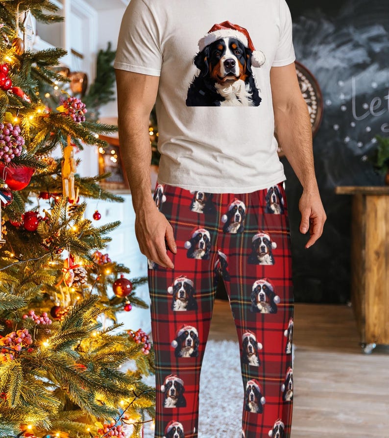 Men's pajama pants lounge wear personalized Christmas pajama bottoms with Bernese Mountain dogs wearing Santa Hat and their name is on the Santa Hat.  Bernese Mountain Dog dad gear!