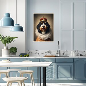 May include: A framed portrait of a dog wearing a crown and a ruffled collar. The dog has black, brown, and white fur and is posed in a regal manner. The artwork has a vintage aesthetic, with warm tones and a soft focus.