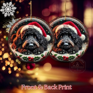 Black bernedoodle or labradoodle dog ceramic ornament show hanging with a gold string.  The ornament measures 3 inches in diameter and is a full gloss, printed on both sides.