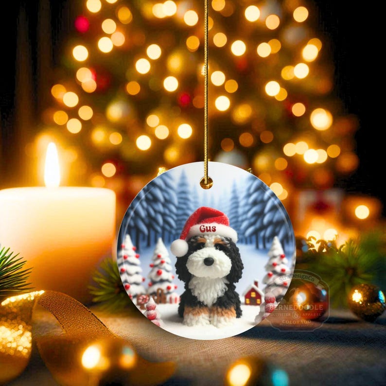 Bernedoodle claymation style ornament made of ceramic, hanging by a gold string.  Winter scene featuring a cute, personalized doodle dog with personalized name on santa hat.  Perfect gift for Bernedoodle Dog Lovers and Pet Enthusiasts.