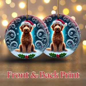 A cozy Christmas ornament featuring a goldendoodle sitting in fluffy snow while wearing a Santa hat with the name “Harper.” Frosty feather-style swirls, glittering stars, and holly berries add decorative flair. The glowing background lights create warmth and charm, making it ideal as a personalized gift or tree decoration.