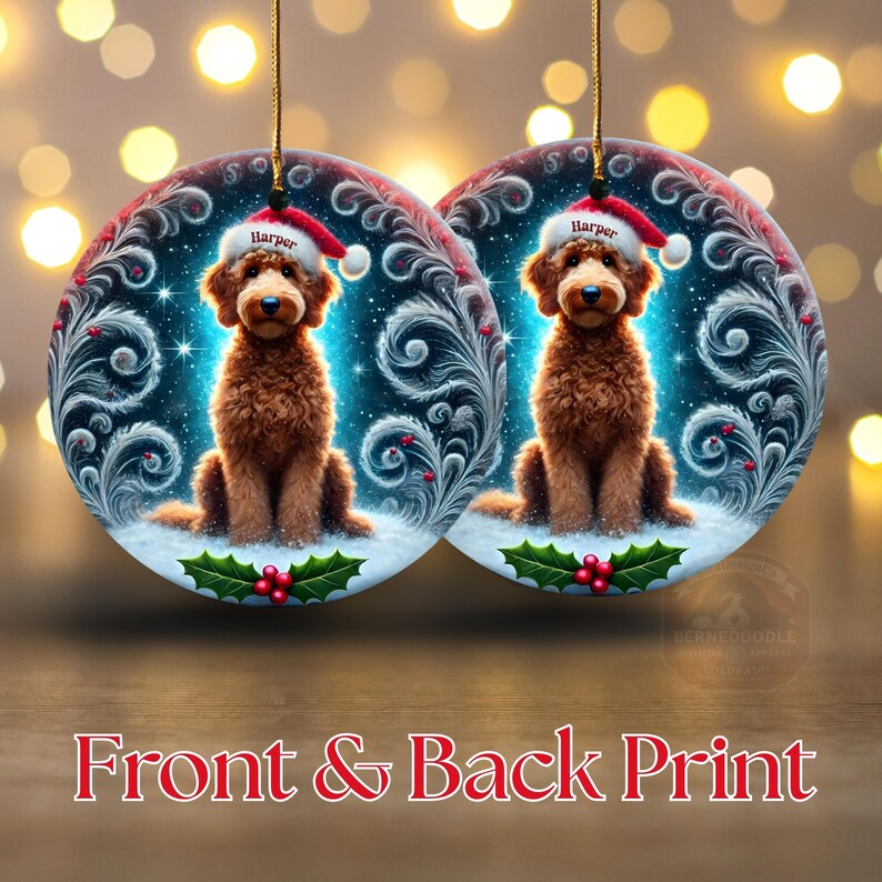 A cozy Christmas ornament featuring a goldendoodle sitting in fluffy snow while wearing a Santa hat with the name “Harper.” Frosty feather-style swirls, glittering stars, and holly berries add decorative flair. The glowing background lights create warmth and charm, making it ideal as a personalized gift or tree decoration.