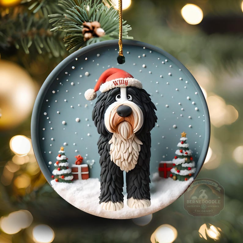 May include: A round Christmas ornament featuring a Bernedoodle dog wearing a Santa hat with the name "Willy". The ornament has a snowy scene with Christmas trees and presents. The dog is black, white, and tan.