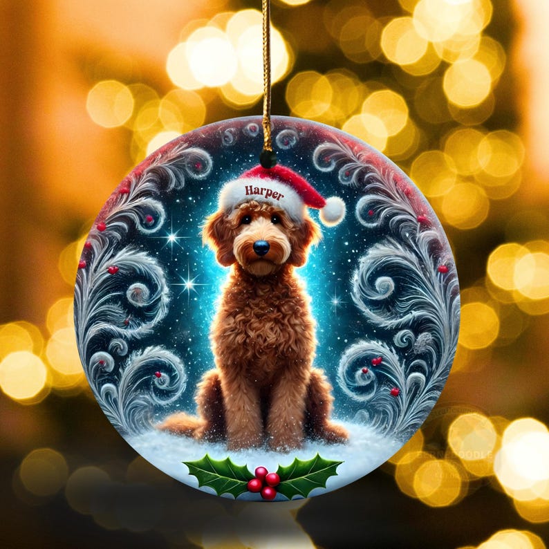 A cozy Christmas ornament featuring a goldendoodle sitting in fluffy snow while wearing a Santa hat with the name “Harper.” Frosty feather-style swirls, glittering stars, and holly berries add decorative flair. The glowing background lights create warmth and charm, making it ideal as a personalized gift or tree decoration.