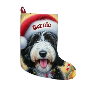 Bernedoodle Christmas stocking with a cute black and white dog wearing a Santa hat and smiling, personalized with the name ‘Bernie’. Festive holiday background with candy canes, lights, and ornaments — perfect personalized dog lover gift, Bernedoodle holiday décor, or custom pet Christmas stocking.