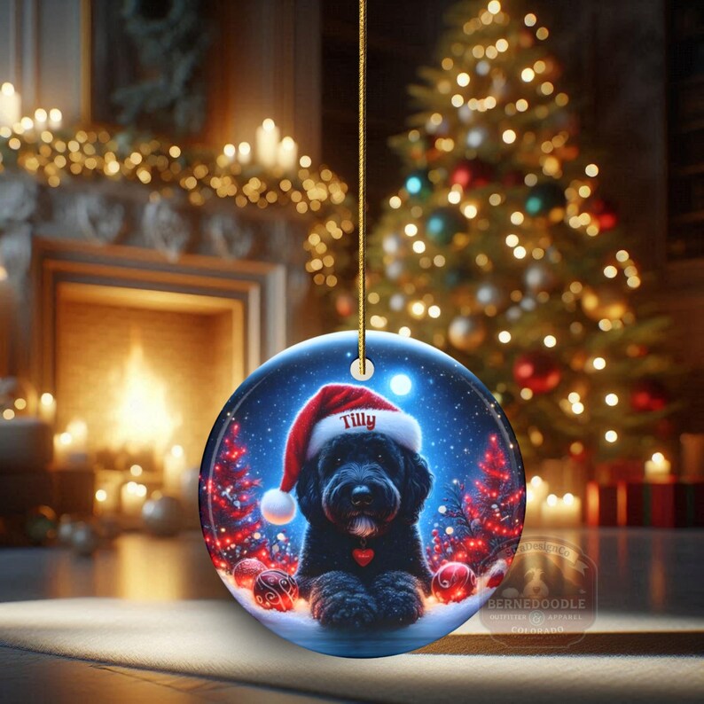 This festive ornament features an adorable black doodle wearing a Santa hat, surrounded by soft glowing holiday lights and rich red Christmas tones. The warm lighting highlights the dog’s fluffy black fur, giving the design a bright, cheerful look that stands out on any tree. A perfect personalized keepsake for anyone who loves black doodles and joyful holiday décor.