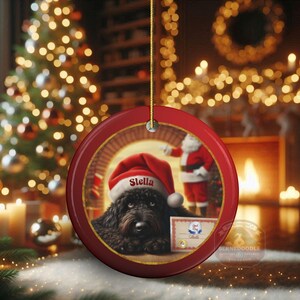 This ceramic ornament features a cute black goldendoodle (or Labradoodle)...Or black bernedoodle dog wearing a Santa hat and being on their best behavior for Santa, surrounded by holiday decorations.  Three inch ceramic dog ornament with a black bernedoodle black golden doodle black goldendoodle dog wearing a santa hat on this cute dog ornament gift.  Perfect ornament for a dog person, dog lover, doodle mom or doodle dad.