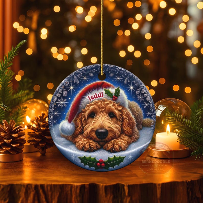 Golden Doodle dog ceramic ornament show hanging with a gold string.  The Goldendoodle Dog ornament measures 3 inches in diameter and is a full gloss, printed on both sides.