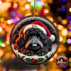 Black bernedoodle or labradoodle dog ceramic ornament show hanging with a gold string.  The ornament measures 3 inches in diameter and is a full gloss, printed on both sides.