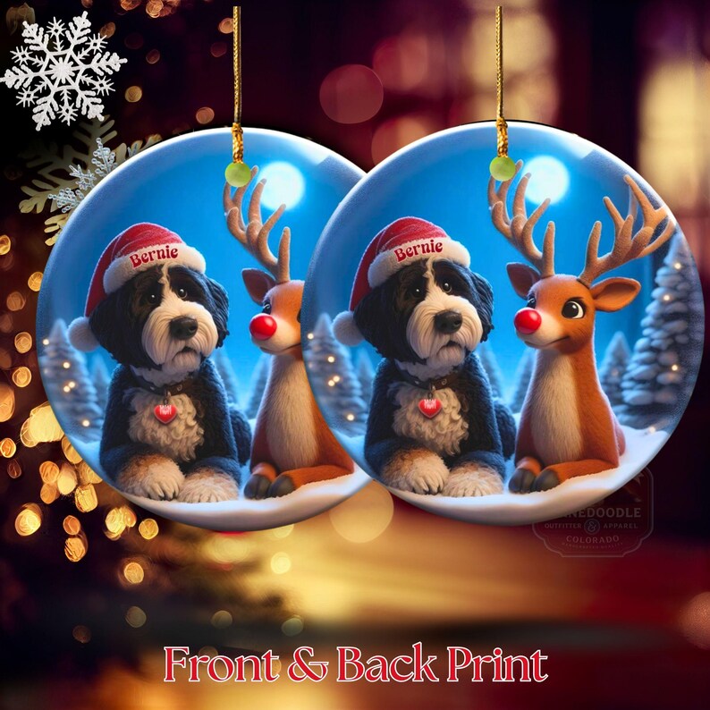 A depiction of the front and back print of a ceramic ornament with a fluffy Bernedoodle sits beside a gentle reindeer with a glowing red nose in a snowy winter forest. Soft blue and golden holiday lighting highlights the animals as snow falls around them. The Bernedoodle’s expressive face and the reindeer’s warm glow create a peaceful, magical Christmas scene perfect for woodland and dog-themed holiday décor.