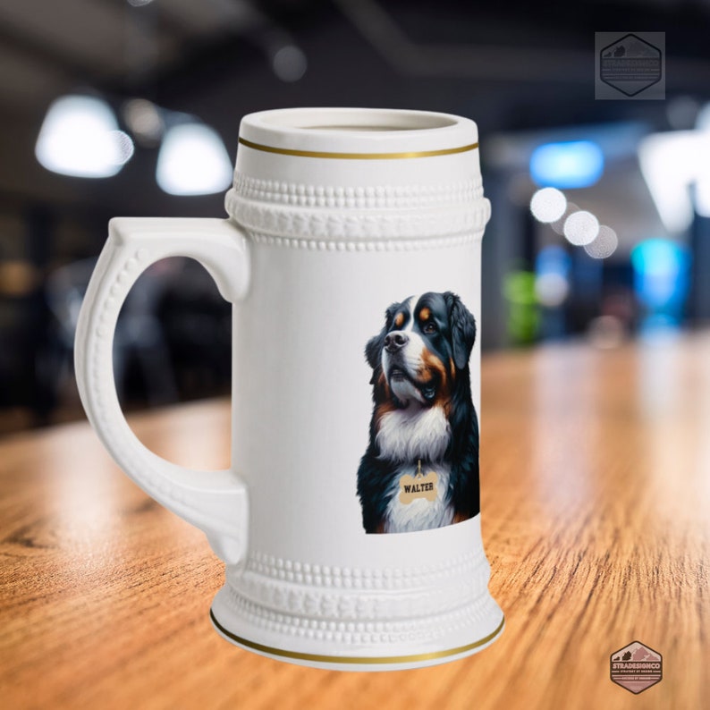 May include: White ceramic beer stein with a gold rim and handle. The stein features a detailed illustration of a Bernese Mountain Dog with a tag that says "Walter". The stein has a decorative embossed design around the top and bottom.