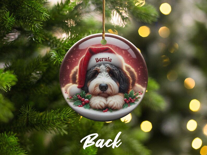 Personalize your holiday decor with this charming Bernedoodle Christmas ornament! Featuring a cute Bernedoodle in a festive Santa hat and customizable name, this round ornament adds warmth and joy to any tree. Perfect for dog lovers and unique gifts!