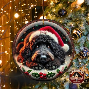 Black bernedoodle or labradoodle dog ceramic ornament show hanging with a gold string.  The ornament measures 3 inches in diameter and is a full gloss, printed on both sides.