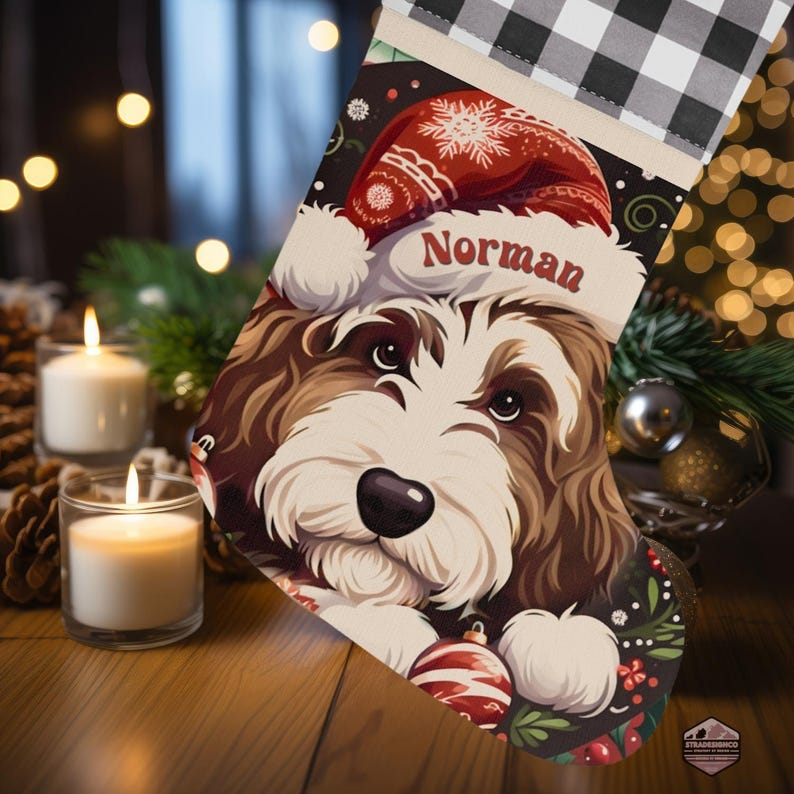 A festive Christmas stocking featuring a whimsical illustrated doodle dog wearing a red Santa hat, surrounded by holiday ornaments and greenery in a warm, detailed Christmas art style. The top of the stocking has a classic red and black buffalo-plaid cuff, and the stocking hangs from a white mantel decorated with evergreen garland and gold ornaments. The stocking design is personalized with your dog’s name, making it a charming and custom holiday décor piece for dog lovers.