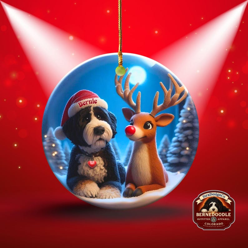 A fluffy Bernedoodle sits beside a gentle reindeer with a glowing red nose in a snowy winter forest. Soft blue and golden holiday lighting highlights the animals as snow falls around them. The Bernedoodle’s expressive face and the reindeer’s warm glow create a peaceful, magical Christmas scene perfect for woodland and dog-themed holiday décor.