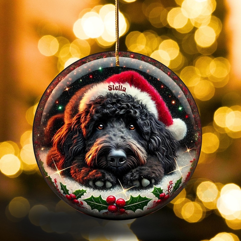 Black bernedoodle or labradoodle dog ceramic ornament show hanging with a gold string.  The ornament measures 3 inches in diameter and is a full gloss, printed on both sides.