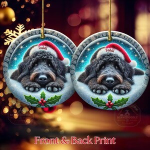 Black goldendoodle ceramic ornament with two sided design.  Black golden doodle , black bernedoodle dog decor.  The picture is showing the ornaments printed on each side.  Gorgeous blue ornament with black doodle dog wearing a santa hat.  Personalized with dog's name.