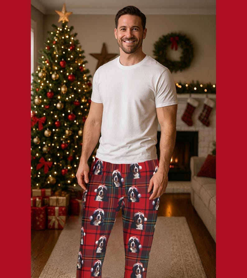 A man seen wearing Men's pajama pants lounge wear personalized Christmas pajama bottoms with Bernese Mountain dogs wearing Santa Hat and their name is on the Santa Hat.  Bernese Mountain Dog dad gear!