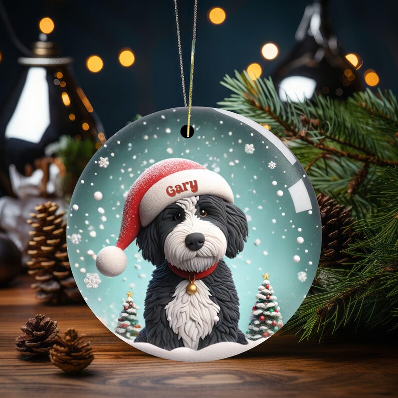 Celebrate the holidays with this adorable Bernedoodle Christmas ornament! Featuring a charming claymation-style Bernie in a Santa hat, surrounded by snowflakes and festive trees, this ornament adds warmth and joy to any holiday decor. For dog lovers!