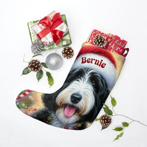 Bernedoodle Christmas stocking with a cute black and white dog wearing a Santa hat and smiling, personalized with the name ‘Bernie’. Festive holiday background with candy canes, lights, and ornaments — perfect personalized dog lover gift, Bernedoodle holiday décor, or custom pet Christmas stocking.