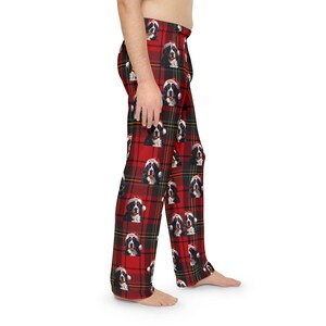 Men's pajama pants lounge wear personalized Christmas pajama bottoms with Bernese Mountain dogs wearing Santa Hat and their name is on the Santa Hat.  Bernese Mountain Dog dad gear!