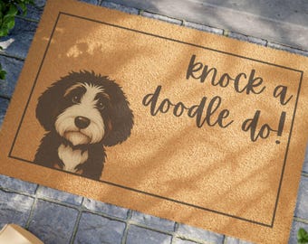 May include: A rectangular doormat with a brown background and a black border. The mat features a black and white dog illustration and the phrase "knock a doodle do!" in a handwritten font.