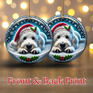 May include: Two round Christmas ornaments featuring a white dog wearing a red Santa hat with the word "Snowflake". The ornaments have a winter scene background with snowflakes and holly. The text "Front & Back Print" is at the bottom.