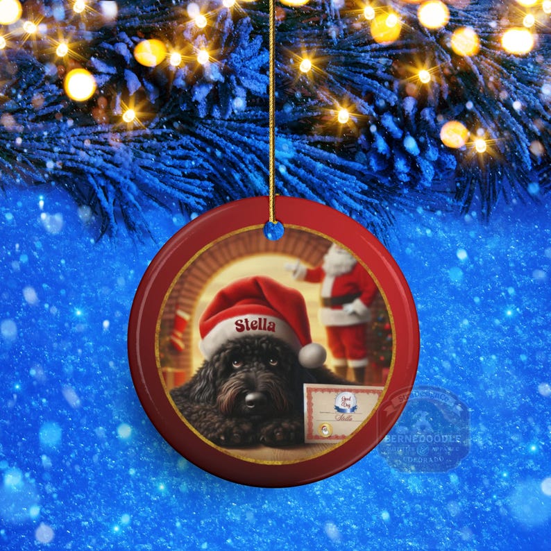 This ceramic ornament features a cute black goldendoodle (or Labradoodle)...Or black bernedoodle dog wearing a Santa hat and being on their best behavior for Santa, surrounded by holiday decorations.  Three inch ceramic dog ornament with a black bernedoodle black golden doodle black goldendoodle dog wearing a santa hat on this cute dog ornament gift.  Perfect ornament for a dog person, dog lover, doodle mom or doodle dad.